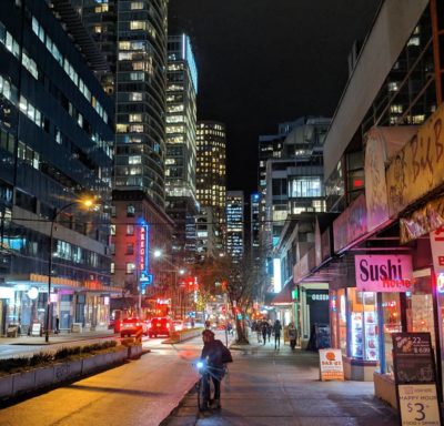 city lights and a guy on a bike