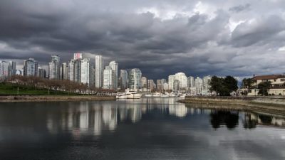 reflected towers under dark clouds