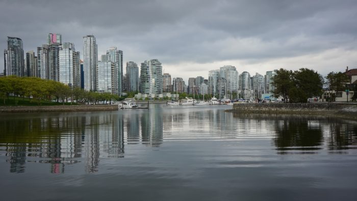 Skyline reflected under grey sky