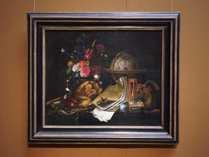 A still life painting with flowers, books and a globe