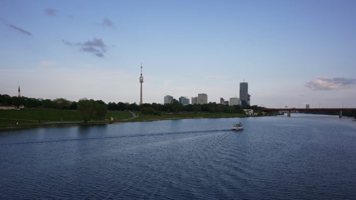 A view of the Danube, with some highrises in the distance, plus the Danube Tower