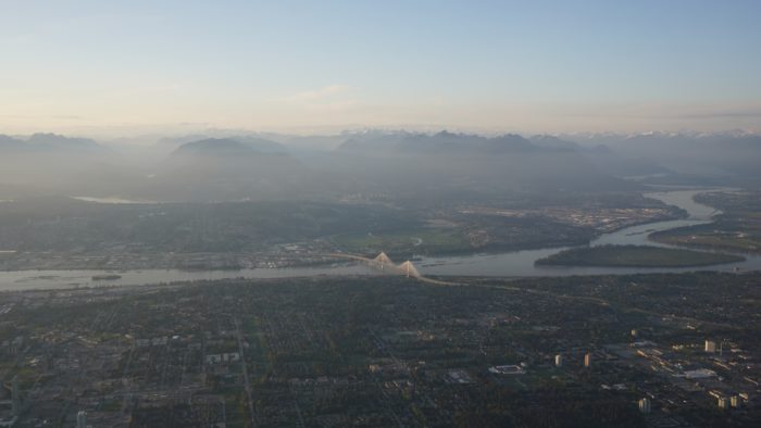 A view of the Fraser River, with mountains as backdrop