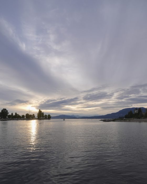 A view out from Sunset Beach. The evening sky is blue-indigo, and the last light is pushing through the clouds.