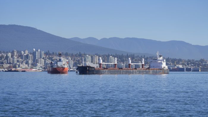 A few big boats in the harbour, with North Vancouver in the background