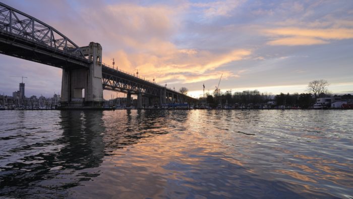 Burrard Bridge and an orange sunset, seen from the Aquatic Centre ferry dock