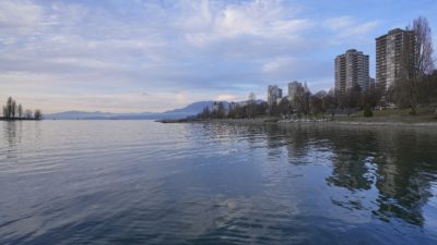 A view of West End towers from the ferry dock. The light is low, and there are a few clouds in the sky