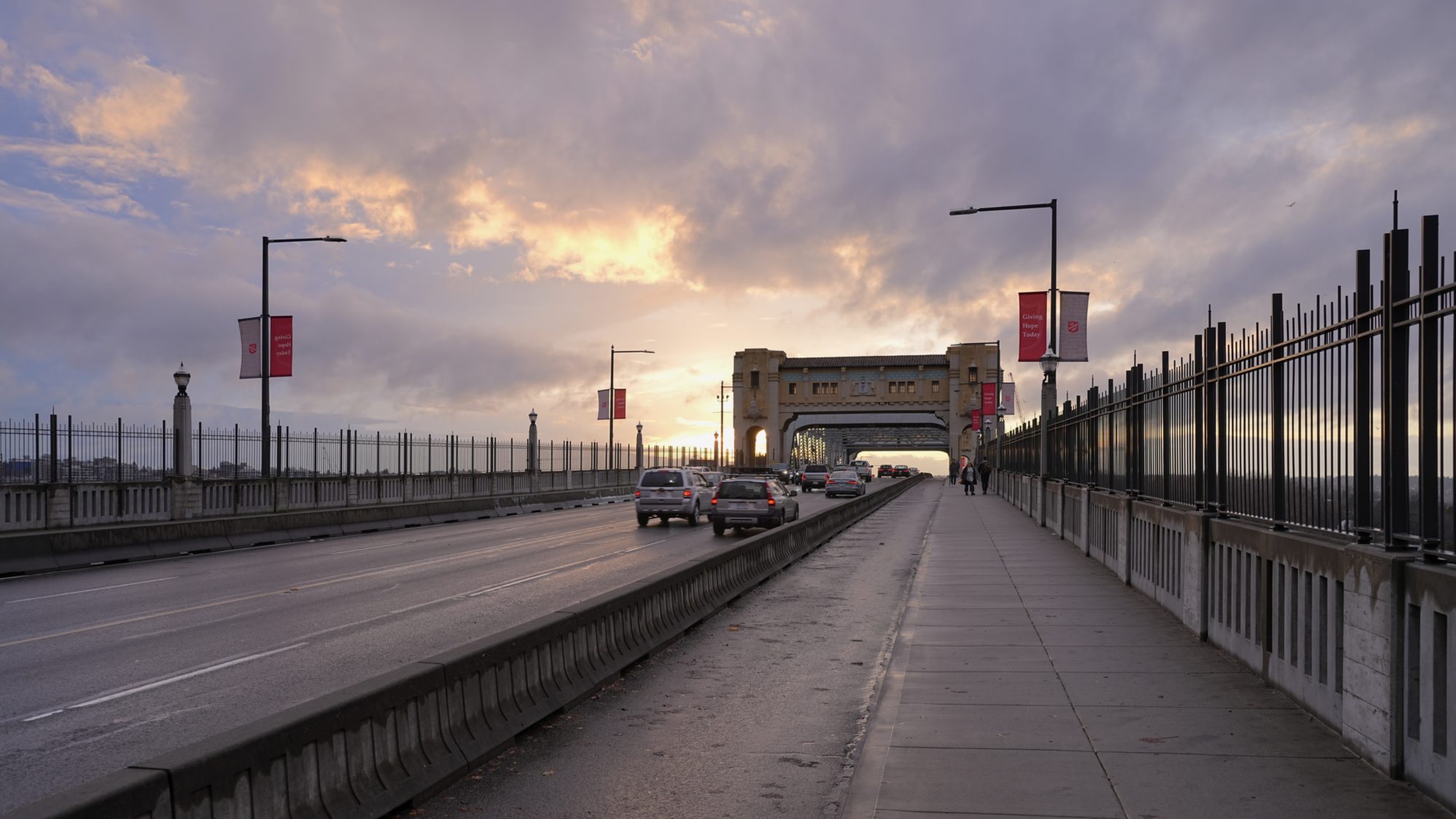 Looking along the length of Burrard Bridge; the sky is purple and gold from the setting sun