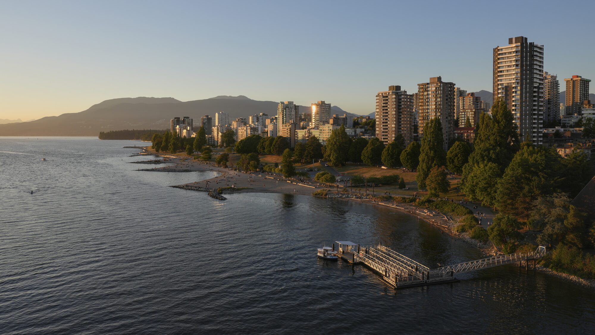 A view of West End towers from Burrard Bridge. The light is low and golden, and the sky is a clear deep blue, with a bit of gold in the west