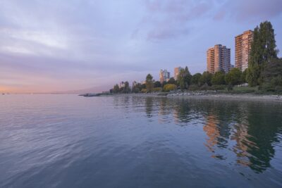 A view of the West End towers from the ferry dock. The light is low, there are some soft clouds in the sky, and a bit of pink over the horizon.